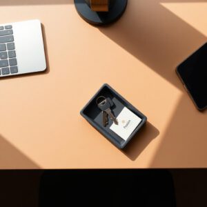 Charcoal desk tray holding keys and cards on a desk